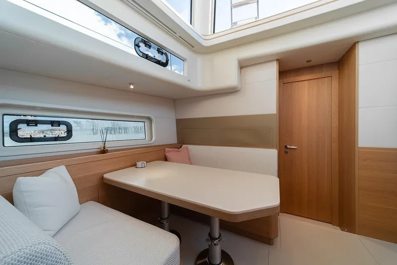  Yacht Photos Pics Luxurious interior of 2026 Omikron Yachts OT-60, featuring modern dining area and natural light.