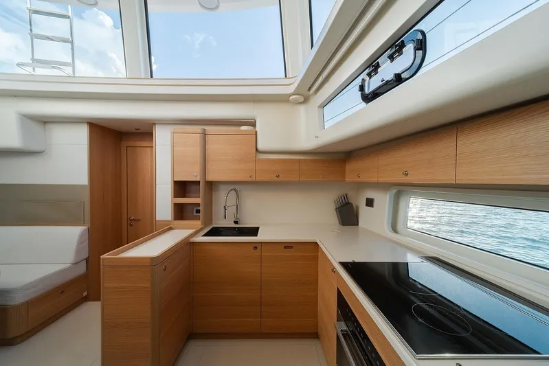  Yacht Photos Pics Modern kitchen interior of 2026 Omikron Yachts OT-60, featuring sleek wood cabinetry and ocean view.
