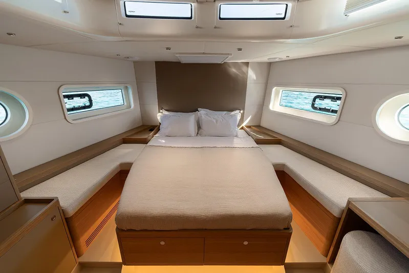  Yacht Photos Pics Luxurious cabin interior of 2026 Omikron Yachts OT-60 with elegant bedding and ocean views.