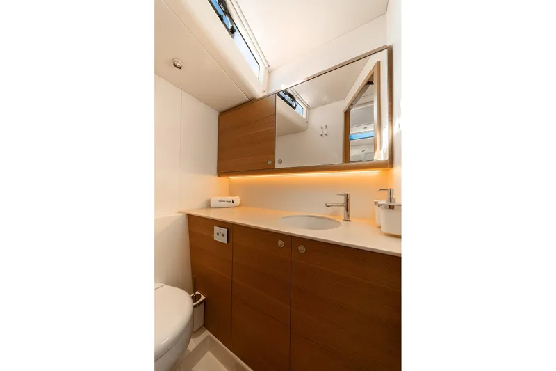  Yacht Photos Pics Luxurious bathroom in 2026 Omikron Yachts OT-60, featuring modern fixtures and wood accents.