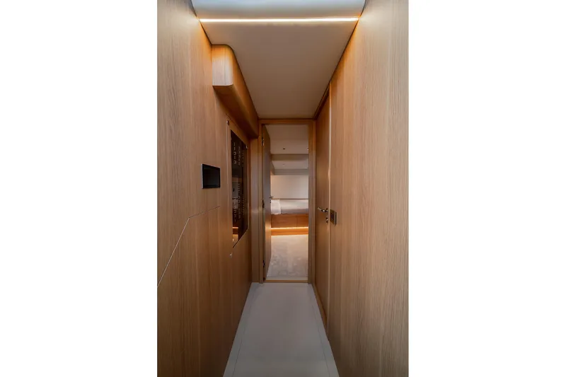 Yacht Photos Pics Modern interior hallway of 2026 Omikron Yachts OT-60, featuring sleek wood paneling.