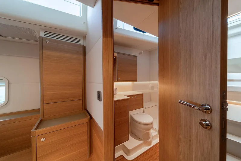  Yacht Photos Pics Luxurious bathroom interior of 2026 Omikron Yachts OT-60, featuring sleek wood finishes.