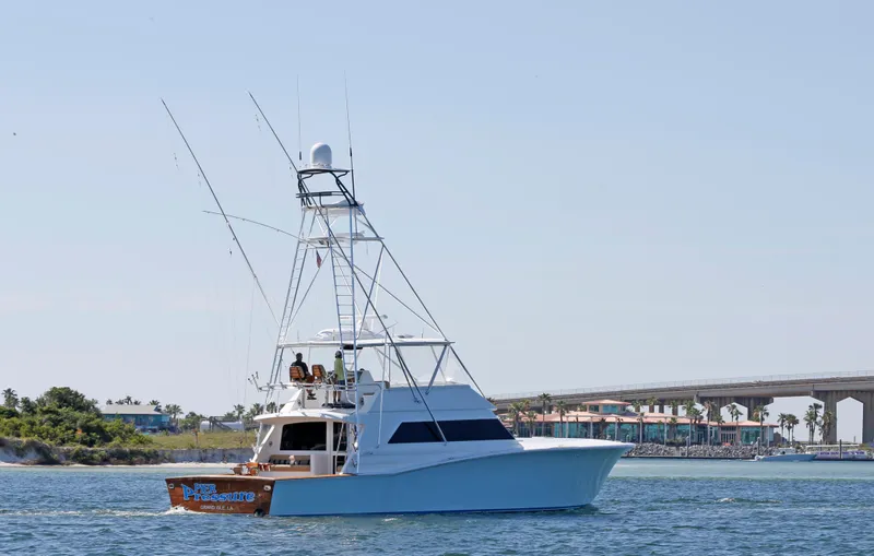 Pier Pressure Yacht Photos Pics Jim Smith 65 Convertible yacht cruising near a coastal bridge, 2000 model.