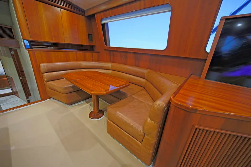 Pier Pressure Yacht Photos Pics Luxurious interior of a 2000 Jim Smith 65 Convertible yacht with leather seating and wooden finishes.