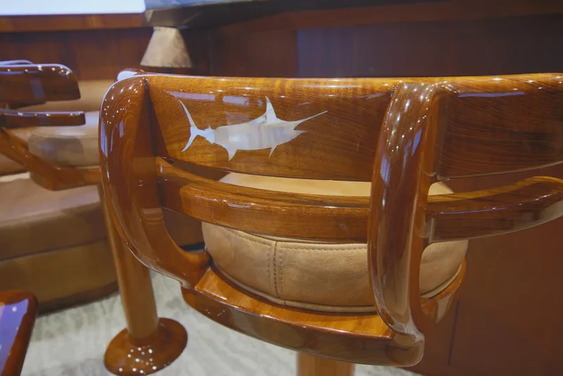 Pier Pressure Yacht Photos Pics Luxurious wooden chair with marlin inlay on a Jim Smith 65 Convertible yacht, 2000 model.