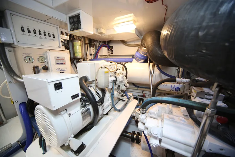 Pier Pressure Yacht Photos Pics Engine room of a 2000 Jim Smith 65 Convertible, featuring machinery and control panels.