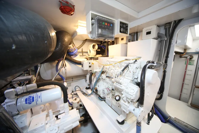 Pier Pressure Yacht Photos Pics Engine room of a 2000 Jim Smith 65 Convertible yacht, showcasing machinery and control panels.