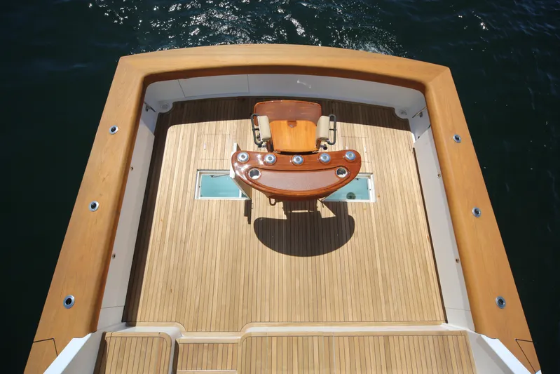 Pier Pressure Yacht Photos Pics Jim Smith 65 Convertible 2000 yacht deck with fishing chair and teak flooring.