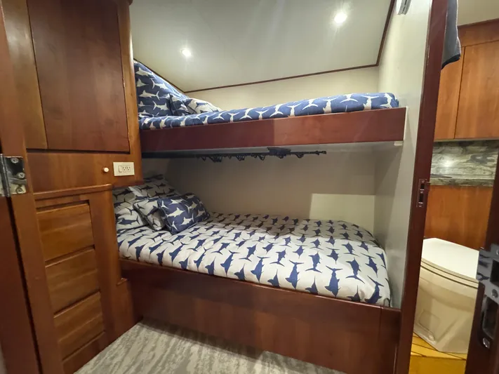 Pier Pressure Yacht Photos Pics Bunk beds with shark-patterned bedding in a Jim Smith 65 Convertible yacht cabin.