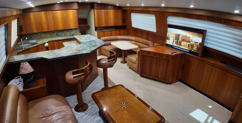 Pier Pressure Yacht Photos Pics Luxurious interior of a 2000 Jim Smith 65 Convertible yacht with wood finishes and modern amenities.