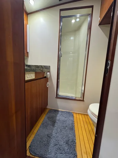 Pier Pressure Yacht Photos Pics Luxurious bathroom in 2000 Jim Smith 65 Convertible yacht with wooden flooring.