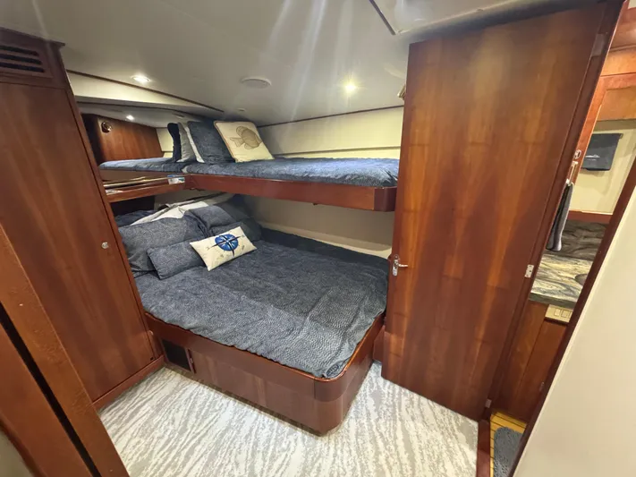 Pier Pressure Yacht Photos Pics Luxurious cabin interior of 2000 Jim Smith 65 Convertible yacht with bunk beds.
