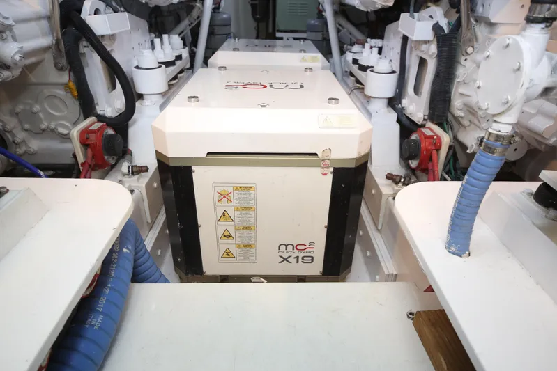 Pier Pressure Yacht Photos Pics Engine room of a 2000 Jim Smith 65 Convertible, featuring an MC2 X19 stabilizer.