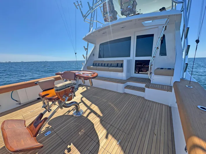 Pier Pressure Yacht Photos Pics Luxurious 2000 Jim Smith 65 Convertible yacht deck with seating, ocean view.