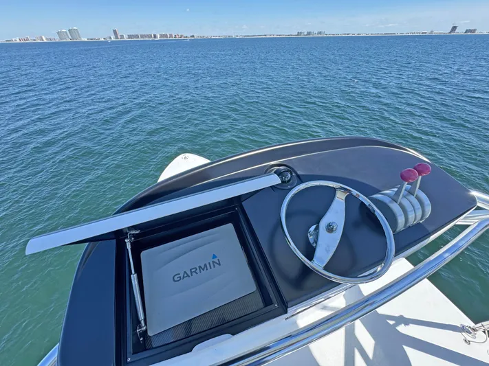 Pier Pressure Yacht Photos Pics Helm of 2000 Jim Smith 65 Convertible with Garmin navigation, overlooking ocean.