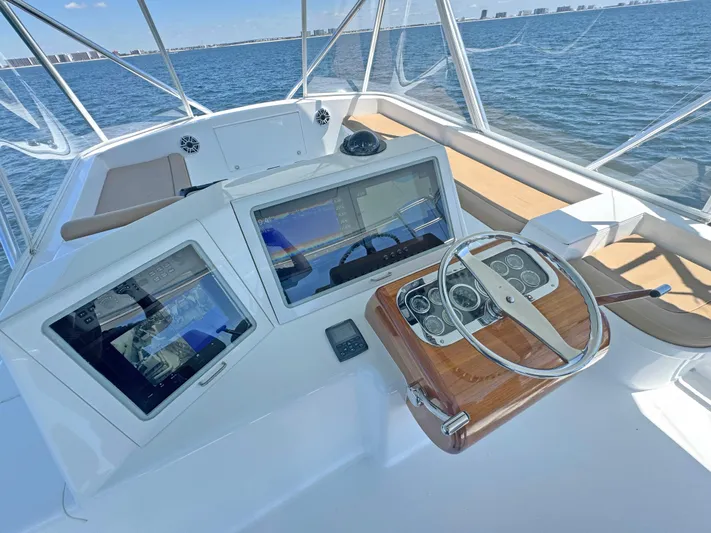 Pier Pressure Yacht Photos Pics Helm of 2000 Jim Smith 65 Convertible yacht with modern navigation displays.