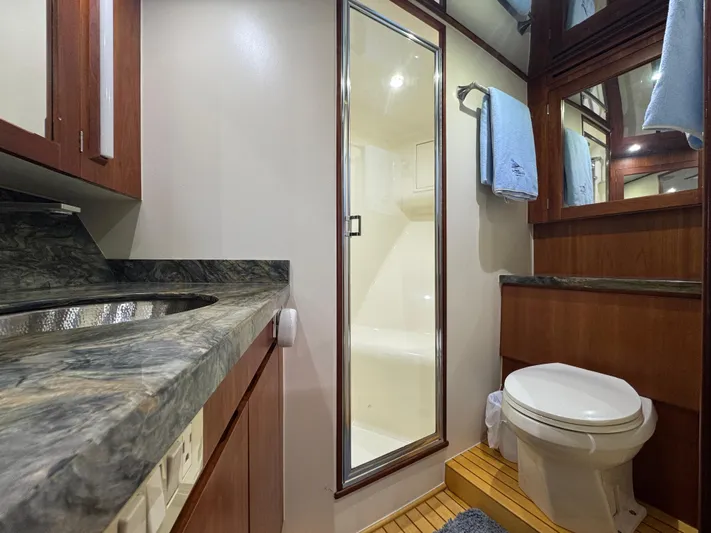 Pier Pressure Yacht Photos Pics Luxurious bathroom in 2000 Jim Smith 65 Convertible yacht with modern fixtures and wood accents.