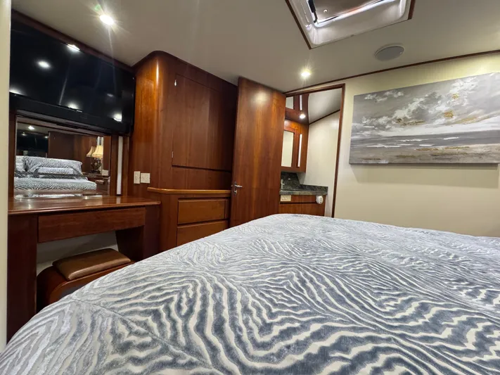 Pier Pressure Yacht Photos Pics Luxurious cabin interior of a 2000 Jim Smith 65 Convertible yacht with elegant wood finishes.
