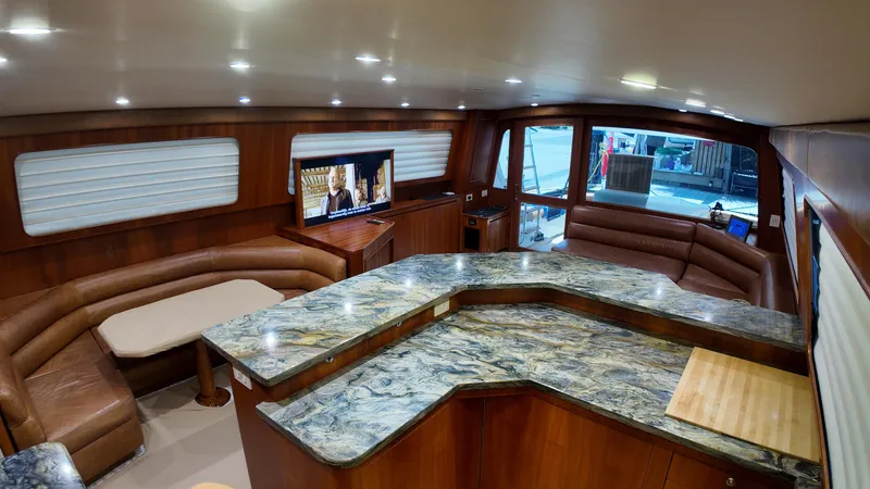 Pier Pressure Yacht Photos Pics Luxurious interior of a 2000 Jim Smith 65 Convertible yacht with elegant wood finishes.