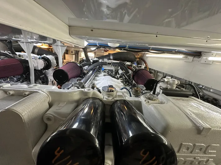 Pier Pressure Yacht Photos Pics Engine room of a 2000 Jim Smith 65 Convertible yacht, showcasing powerful machinery.