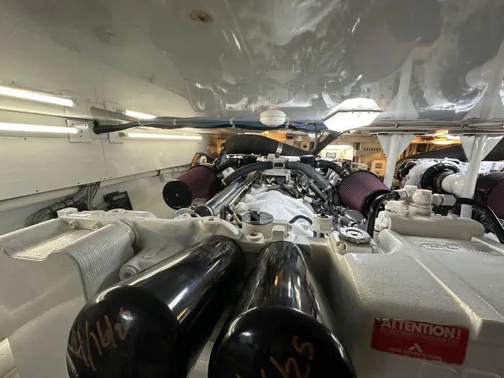 Pier Pressure Yacht Photos Pics Engine room of a 2000 Jim Smith 65 Convertible, showcasing powerful machinery and components.