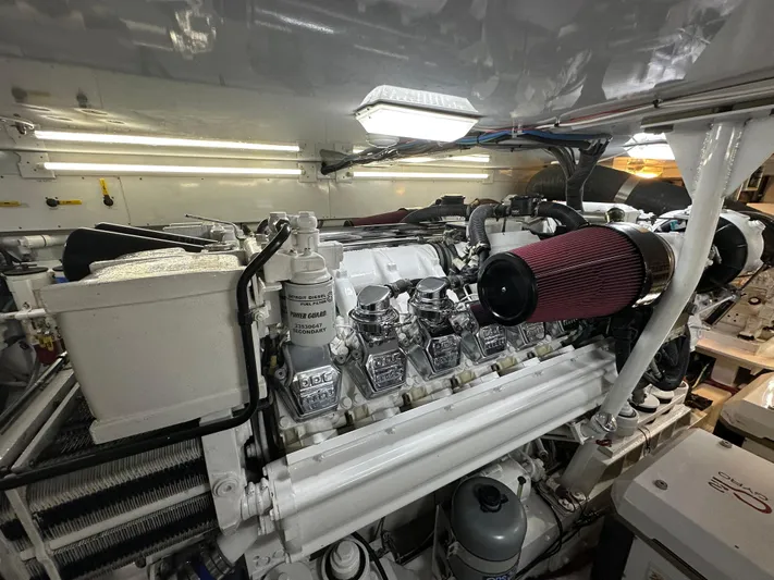 Pier Pressure Yacht Photos Pics Engine room of a 2000 Jim Smith 65 Convertible, showcasing a powerful marine engine.