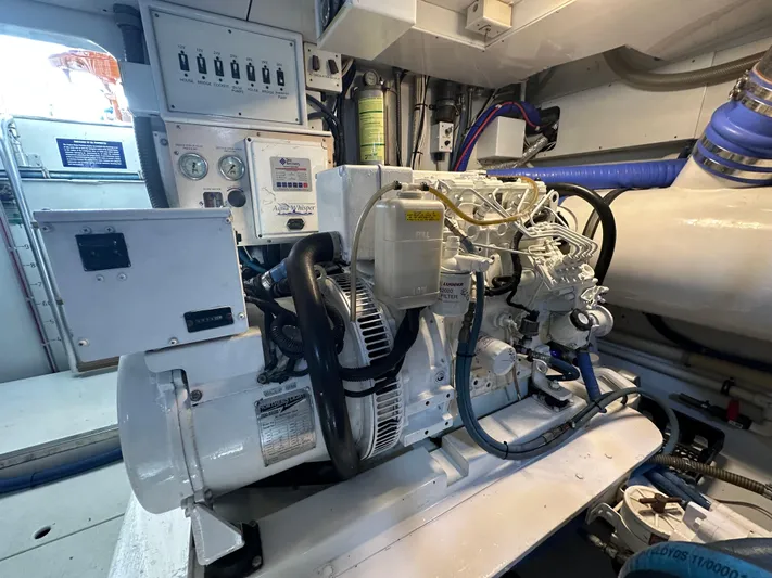 Pier Pressure Yacht Photos Pics Engine room of a 2000 Jim Smith 65 Convertible, showcasing machinery and control panels.