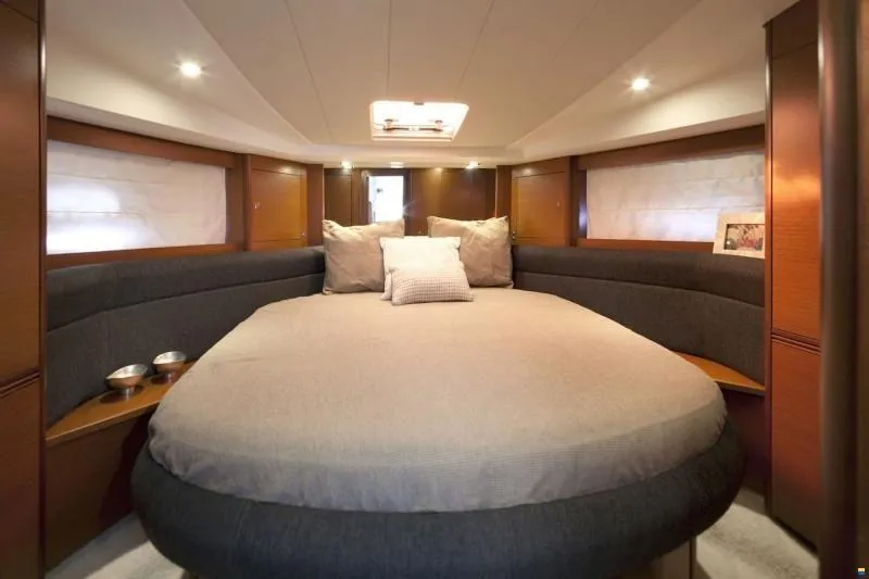  Yacht Photos Pics Luxurious cabin interior of 2012 Prestige 440 S yacht with cozy bedding and ambient lighting.