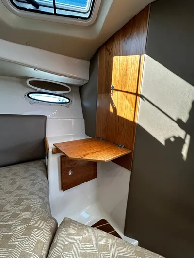 Silver Eagle Yacht Photos Pics 2024 Cutwater 32 Coupe NW Edition interior with foldable wooden table and cushioned seating.