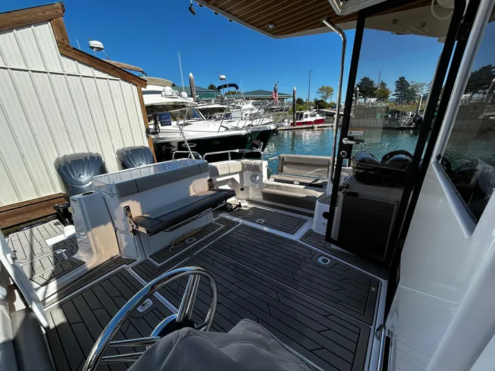 Silver Eagle Yacht Photos Pics 2024 Cutwater 32 Coupe NW Edition boat interior at marina, featuring seating and helm.