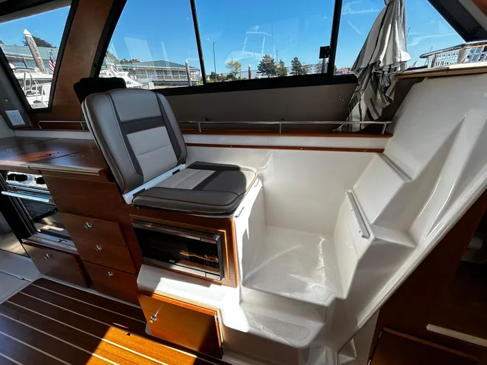 Silver Eagle Yacht Photos Pics 2024 Cutwater 32 Coupe NW Edition interior with seating and wooden cabinetry.