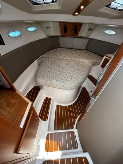 Silver Eagle Yacht Photos Pics 2024 Cutwater 32 Coupe NW Edition interior with elegant wood flooring and cozy sleeping area.