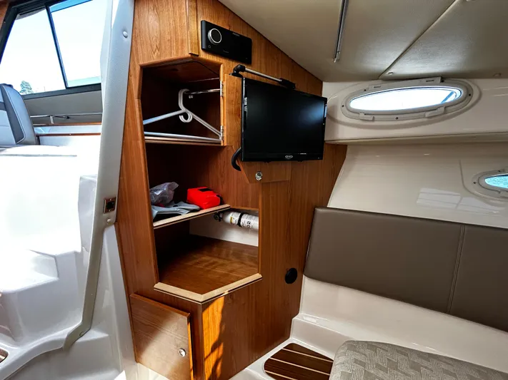 Silver Eagle Yacht Photos Pics 2024 Cutwater 32 Coupe NW Edition interior with TV, storage, and seating area.