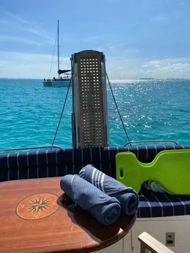 Venko Yacht Photos Pics 2006 Sunseeker Manhattan 50 yacht with ocean view, towels, and green float.