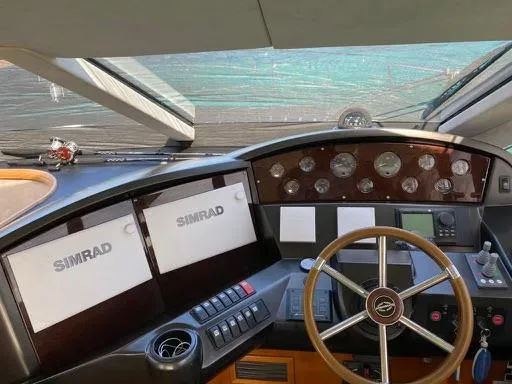 Venko Yacht Photos Pics Sunseeker Manhattan 50 2006 yacht helm with Simrad navigation system and wooden steering wheel.