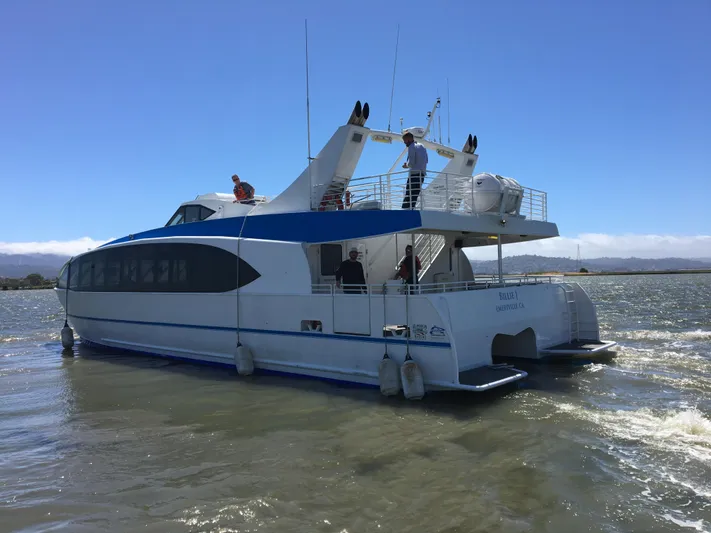 Billie J Yacht Photos Pics High-speed passenger boat, Custom model, 2008, navigating calm waters under a clear blue sky.