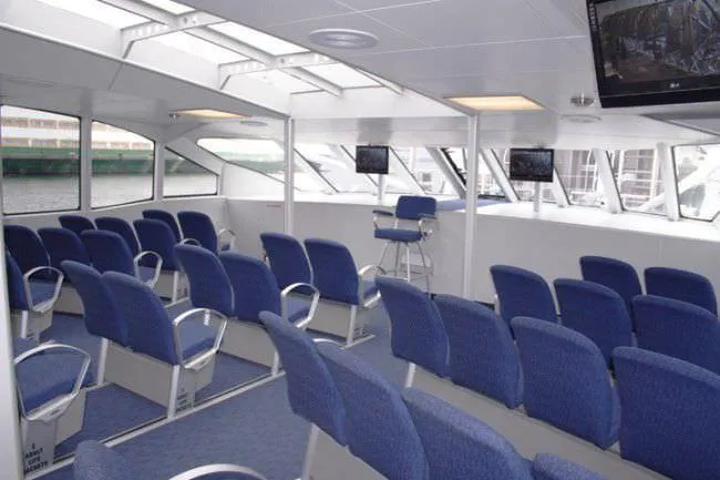 Billie J Yacht Photos Pics Interior of 2008 Custom High Speed 70pax COI Passenger vessel with blue seating.