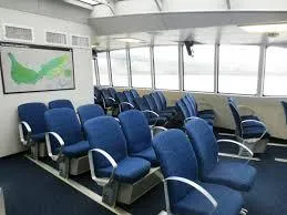 Billie J Yacht Photos Pics Interior of 2008 Custom High Speed 70pax COI Passenger vessel with blue seating.