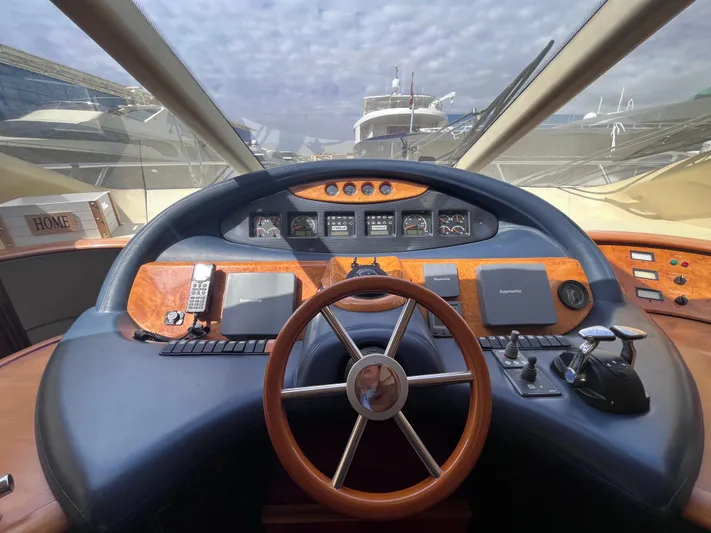  Yacht Photos Pics Helm of 2004 Azimut 55 yacht with wooden steering wheel and navigation instruments.
