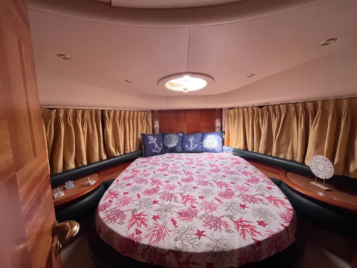  Yacht Photos Pics Luxurious bedroom interior of a 2004 Azimut 55 yacht with nautical-themed bedding.