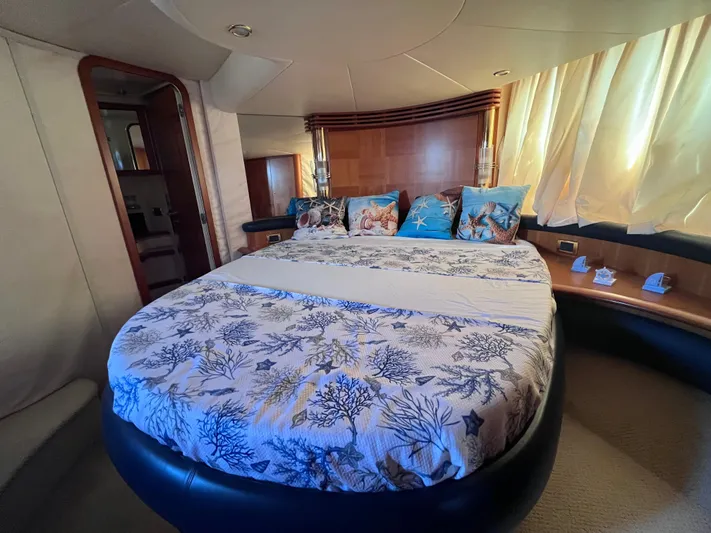  Yacht Photos Pics Luxurious bedroom interior of a 2004 Azimut 55 yacht with elegant bedding and decor.