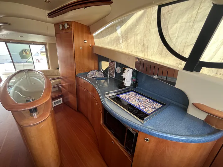  Yacht Photos Pics Luxurious interior of a 2004 Azimut 55 yacht with elegant wood and modern amenities.