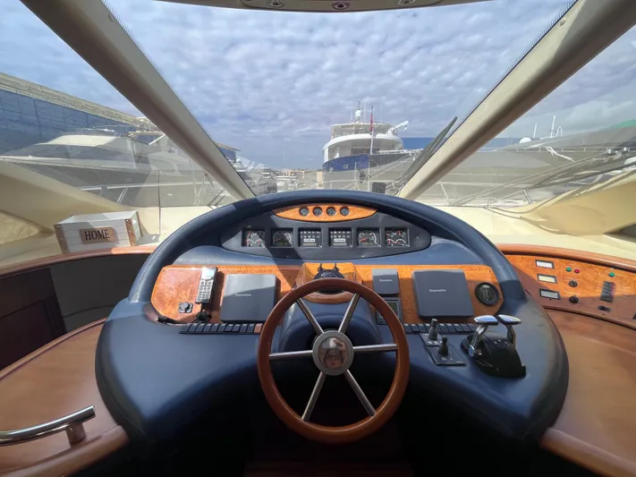  Yacht Photos Pics Helm of 2004 Azimut 55 yacht with wooden steering wheel and control panel.