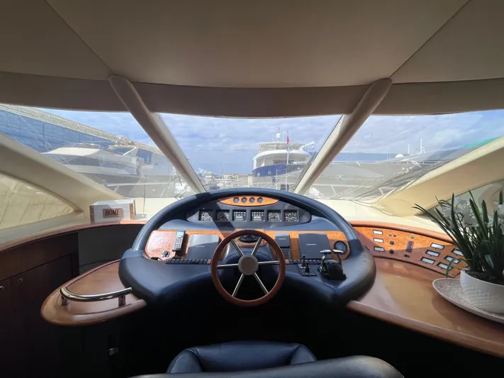  Yacht Photos Pics Interior view of 2004 Azimut 55 yacht cockpit with steering wheel and control panel.