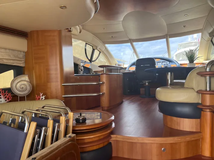  Yacht Photos Pics Luxurious interior of a 2004 Azimut 55 yacht with elegant wood finishes and modern seating.
