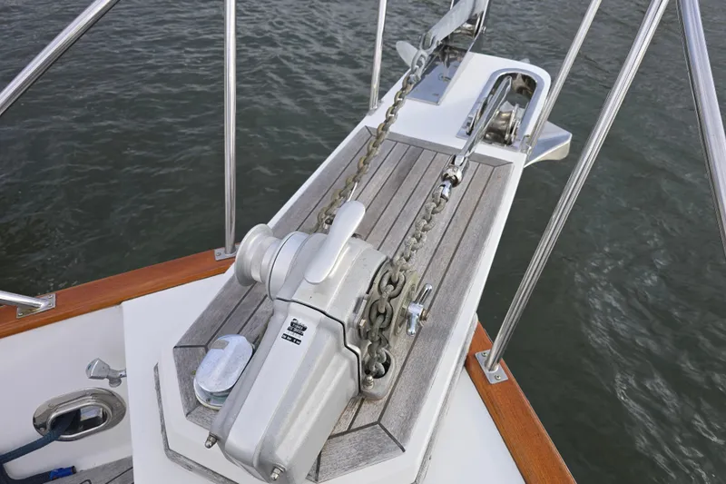 Halcyon Yacht Photos Pics Anchor winch on 2005 Grand Banks 46 Europa yacht deck, with stainless steel railings.