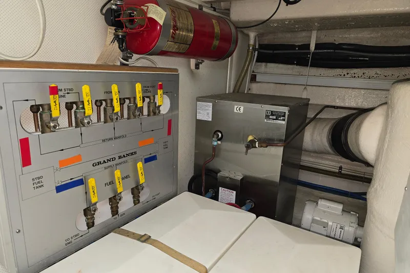 Halcyon Yacht Photos Pics Engine room of 2005 Grand Banks 46 Europa with fuel manifold and fire extinguisher.