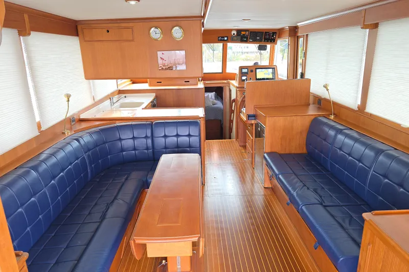 Halcyon Yacht Photos Pics Luxurious interior of 2005 Grand Banks 46 Europa yacht with blue leather seating.