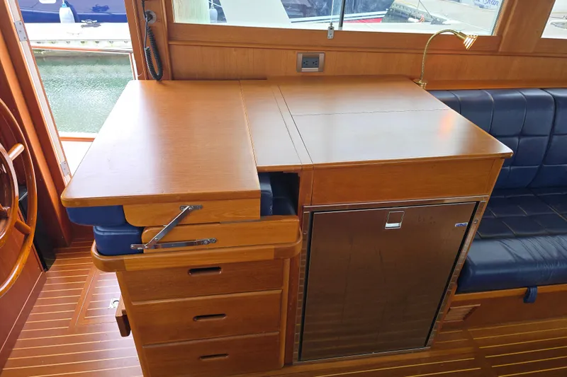 Halcyon Yacht Photos Pics Interior of 2005 Grand Banks 46 Europa yacht with wooden cabinetry and seating.