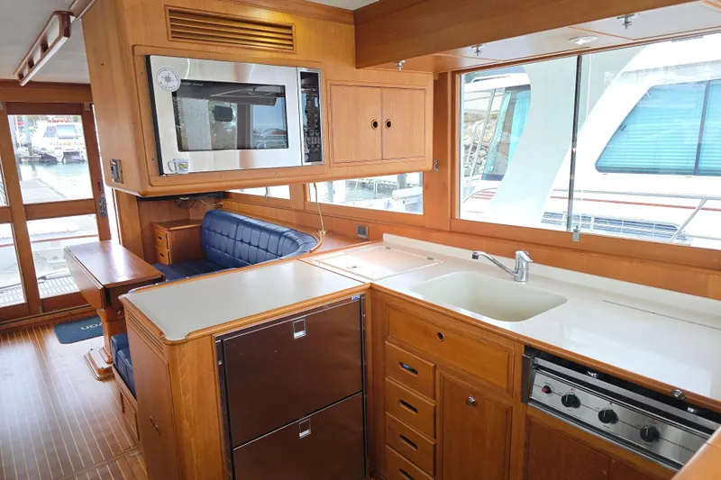 Halcyon Yacht Photos Pics Interior of 2005 Grand Banks 46 Europa yacht with kitchen and seating area.